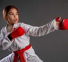 Child wearing mouthguard practicing karate