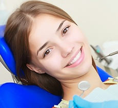 Young girl in dental chair smiling