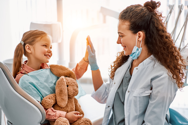 Younger patient smiling at dental exam